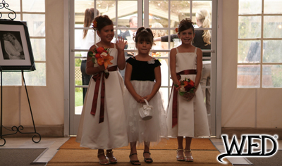 wedding reception flower girls smiling during their grand entrance and Wedding Entertainment Director® logo